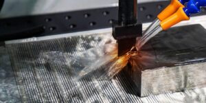 Electrochemical milling tool cutting a metal surface with electrolyte jet and spark erosion for high-precision machining